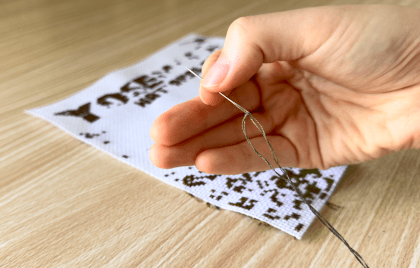 Threading a needle with embroidery floss