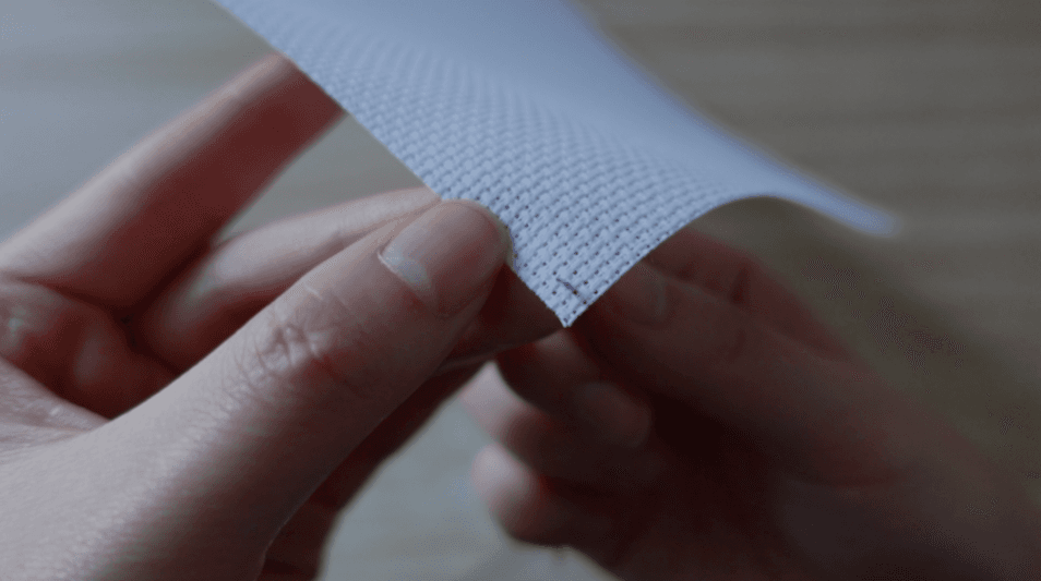 Locating a hole in Aida fabric and bringing the needle up from the back